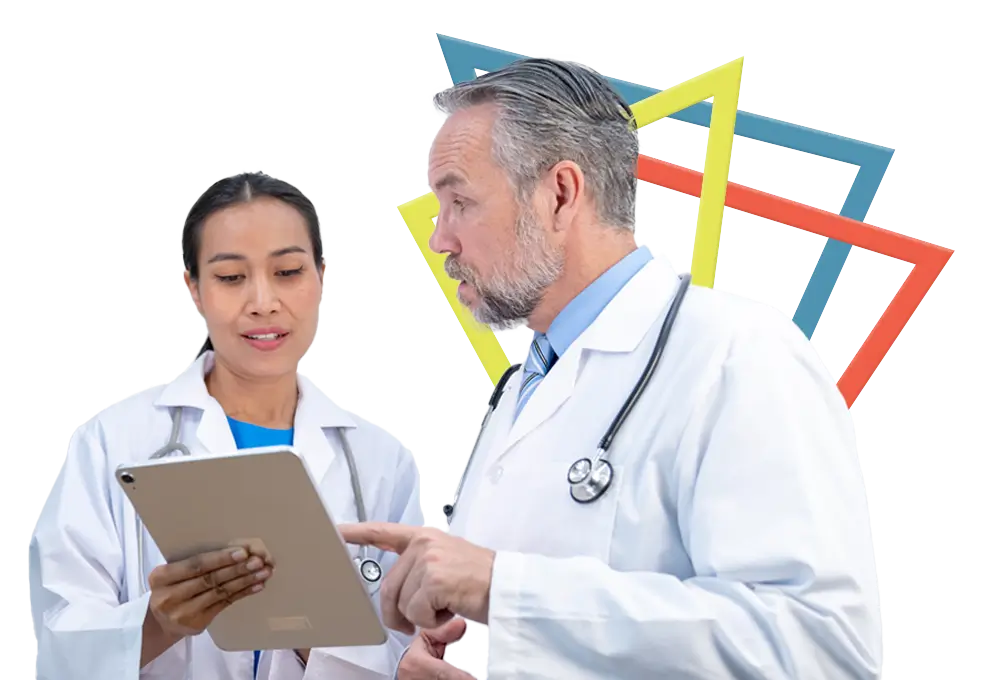 Two doctors in discussion looking at a clipboard.