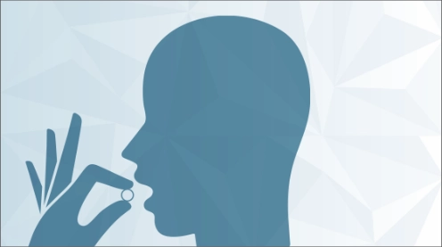 Silhouette of a person taking a pill